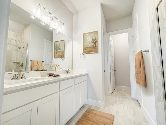 bathroom with a shower with shower door and vanity