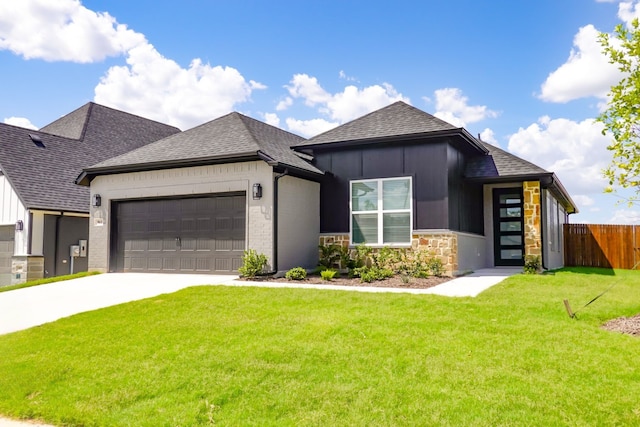 view of front of property with a front lawn and a garage