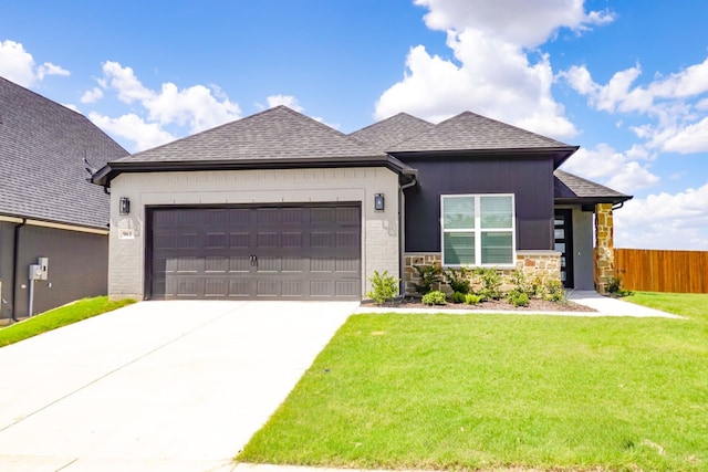 view of front of home with a garage and a front yard