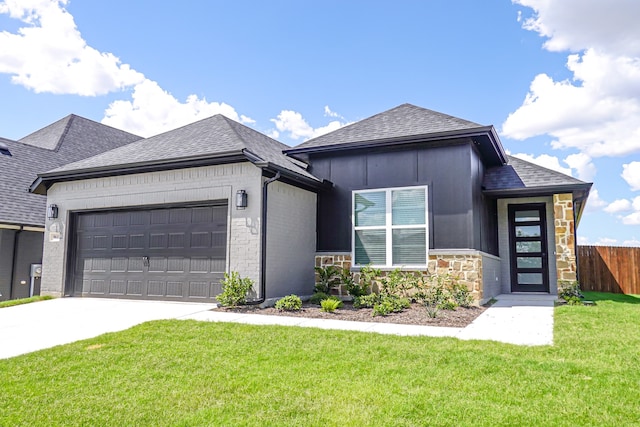 view of front of house with a garage and a front yard