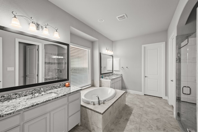 bathroom with tile patterned flooring, plus walk in shower, and vanity