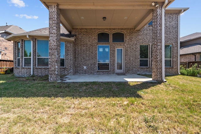 rear view of house with a patio area and a yard