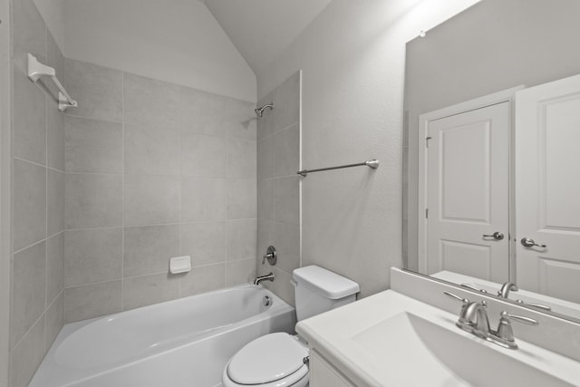 full bathroom with toilet, vanity, tiled shower / bath, and lofted ceiling