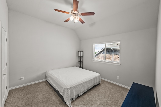 bedroom featuring ceiling fan, vaulted ceiling, and light colored carpet