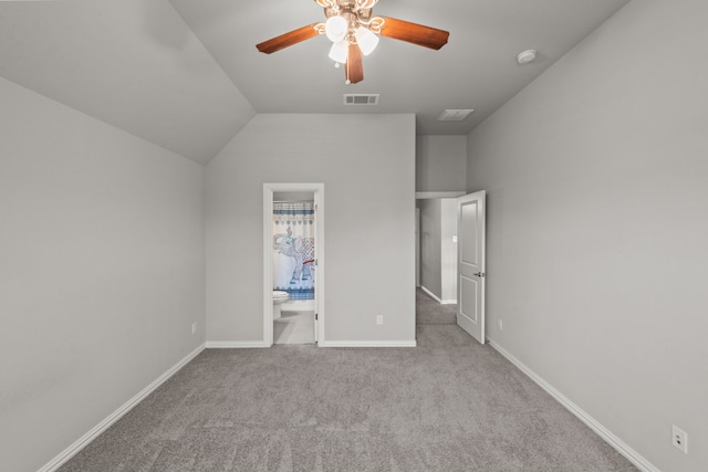 unfurnished bedroom with carpet, ensuite bath, lofted ceiling, and ceiling fan