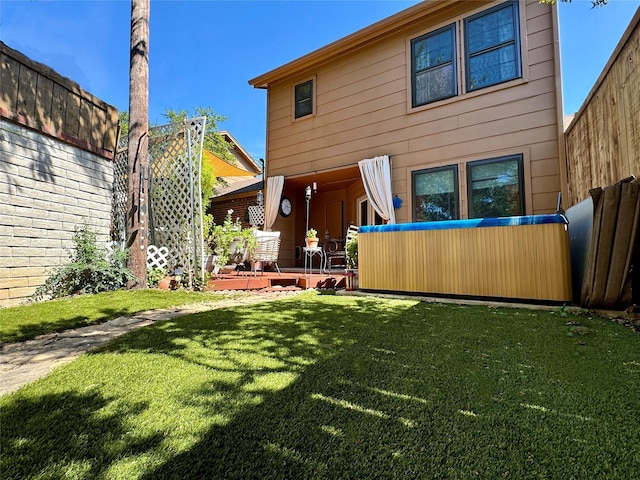 rear view of property featuring a lawn