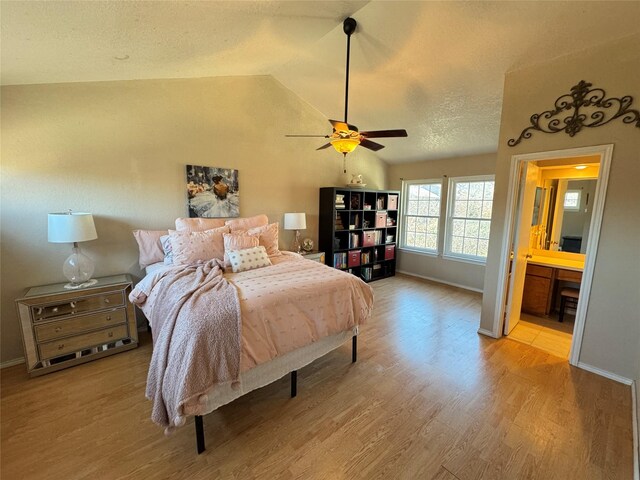 interior space featuring lofted ceiling, hardwood / wood-style floors, and a textured ceiling