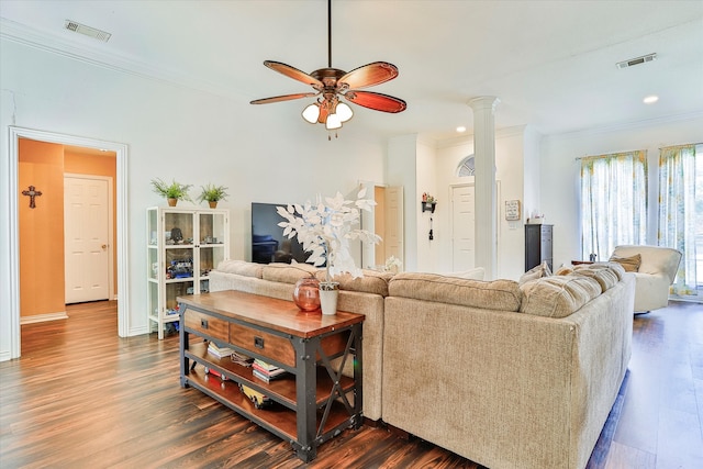 living room with ceiling fan, dark hardwood / wood-style flooring, decorative columns, and ornamental molding