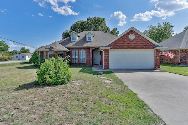 view of front of house featuring a garage and a front lawn