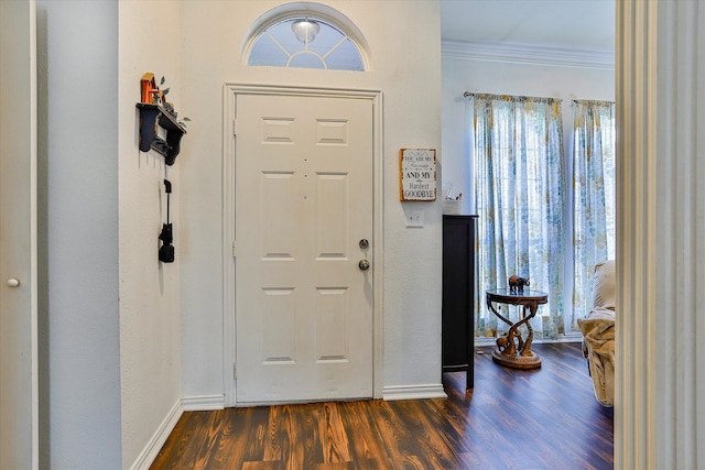 foyer entrance with dark hardwood / wood-style flooring and ornamental molding