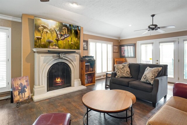 living room featuring ceiling fan, vaulted ceiling, crown molding, and hardwood / wood-style flooring