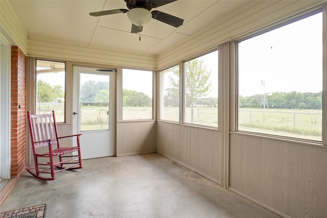 sunroom / solarium featuring ceiling fan