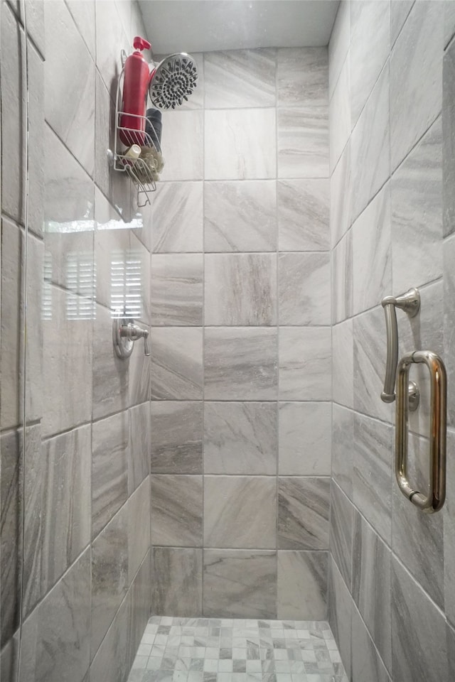 bathroom featuring a shower with door