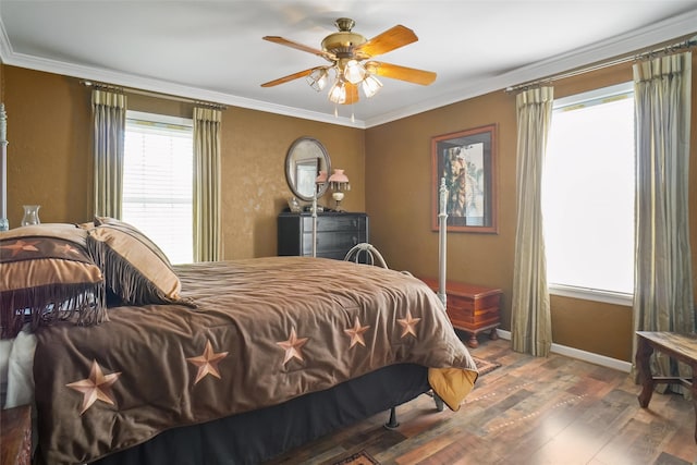 bedroom with ceiling fan, dark wood-type flooring, and ornamental molding