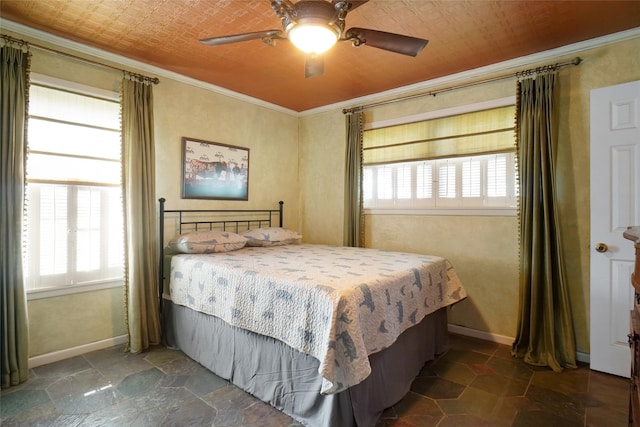 tiled bedroom with ceiling fan and ornamental molding