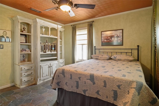 bedroom featuring ceiling fan, crown molding, and dark tile patterned floors