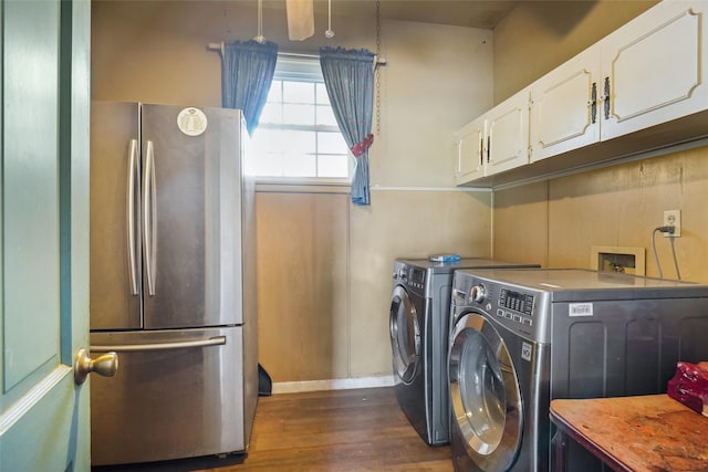 laundry room with cabinets, dark wood-type flooring, and washer and clothes dryer