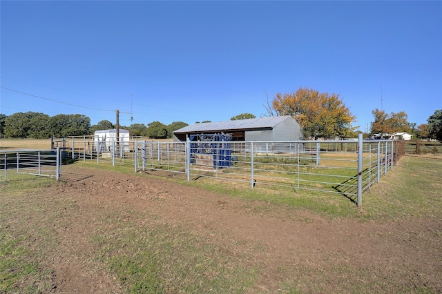 view of yard featuring a rural view and an outdoor structure