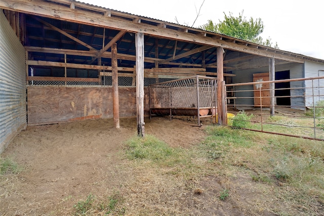 view of horse barn featuring an outbuilding