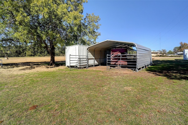 view of outbuilding featuring a carport and a yard