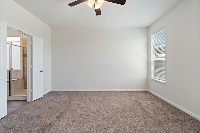 unfurnished room featuring dark carpet and ceiling fan