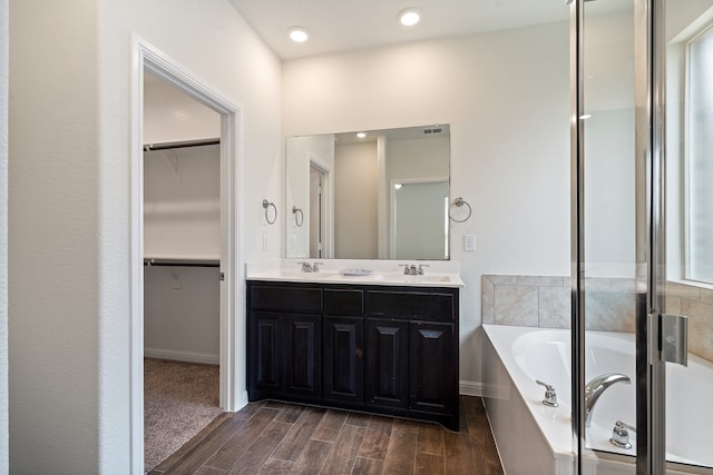 bathroom featuring vanity, hardwood / wood-style flooring, and independent shower and bath