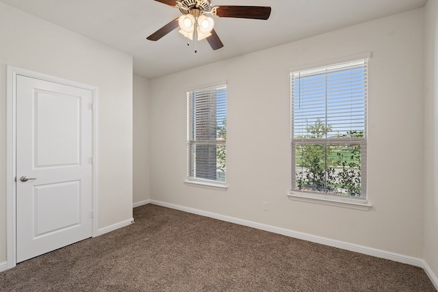 carpeted spare room with ceiling fan