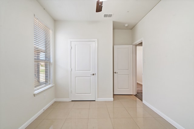 unfurnished bedroom featuring ceiling fan and light tile patterned floors