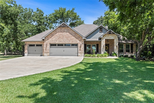 craftsman-style house featuring a garage and a front lawn