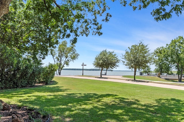 view of property's community with a yard and a water view