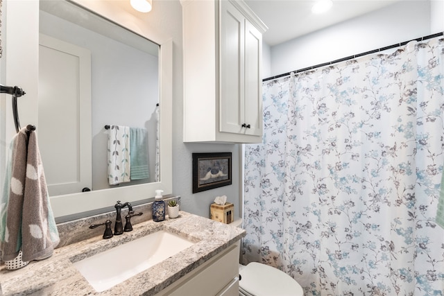 bathroom with vanity and toilet