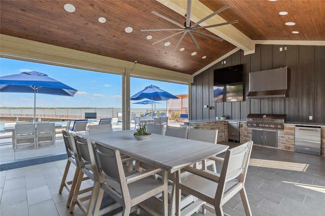 view of patio / terrace featuring ceiling fan, a grill, and an outdoor kitchen