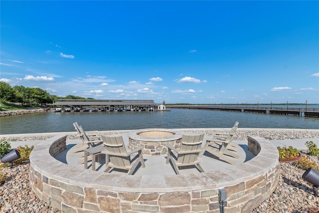 view of patio / terrace featuring an outdoor fire pit and a water view