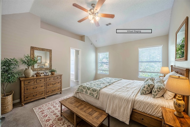 bedroom with multiple windows, vaulted ceiling, light carpet, and ceiling fan