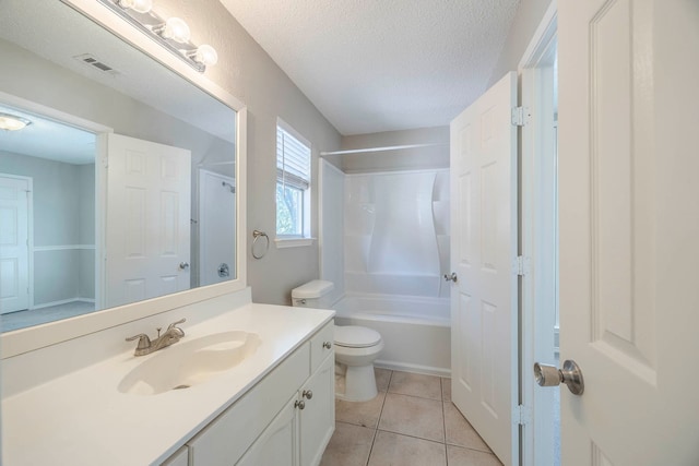 full bathroom with vanity, toilet, a textured ceiling,  shower combination, and tile patterned flooring