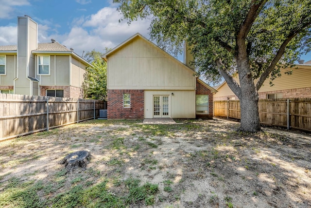 back of property featuring central AC unit and french doors