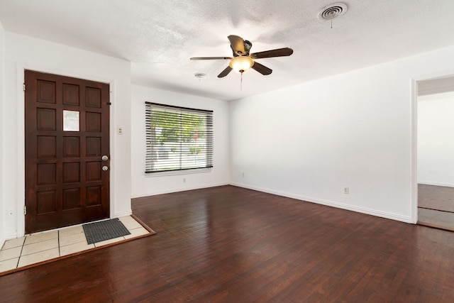 entrance foyer with hardwood / wood-style flooring, a textured ceiling, and ceiling fan