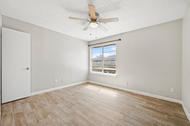 empty room featuring a textured ceiling, light hardwood / wood-style flooring, and ceiling fan