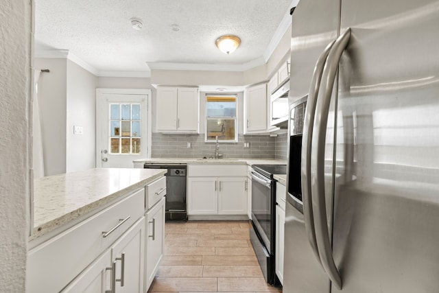 kitchen with appliances with stainless steel finishes, white cabinetry, ornamental molding, and backsplash