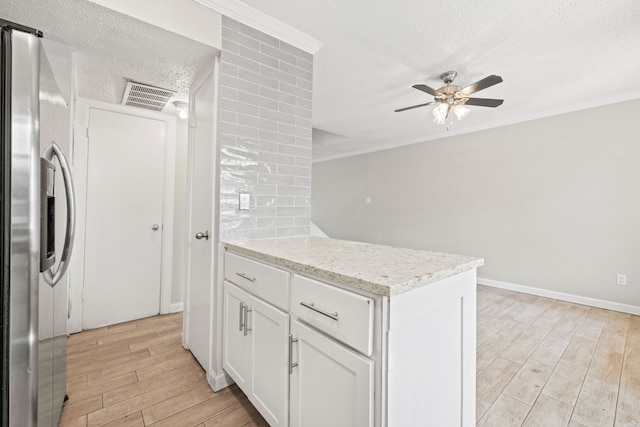 kitchen with light hardwood / wood-style flooring, ceiling fan, stainless steel fridge, crown molding, and white cabinets