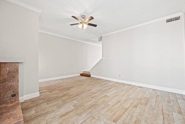 unfurnished room with ceiling fan, light wood-type flooring, a textured ceiling, and ornamental molding