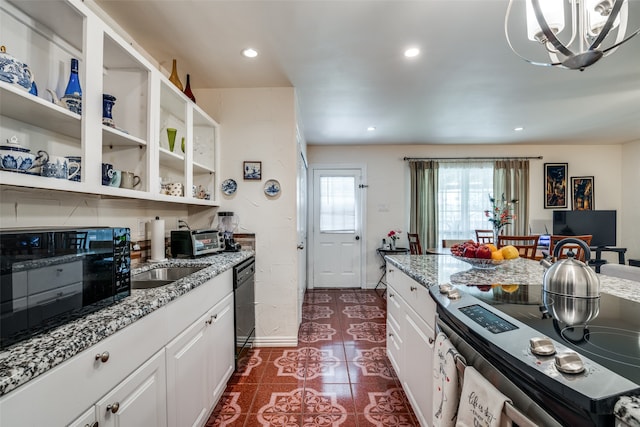 kitchen featuring dark tile patterned flooring, dishwasher, white cabinetry, and stainless steel range with electric stovetop