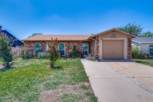 ranch-style home featuring a garage and a front yard