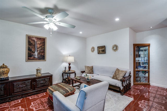 living room featuring ceiling fan and tile patterned floors