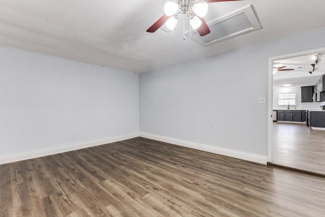 empty room with dark hardwood / wood-style floors and sink