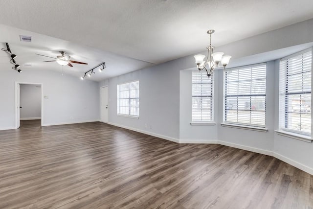 unfurnished room featuring a textured ceiling, ceiling fan with notable chandelier, dark wood-type flooring, and track lighting