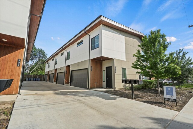 2120 Lovedale Ave Unit 101, Dallas, TX 75235 - kitchen featuring wall chimney exhaust hood, a sink, dark countertops, stainless steel appliances, and light wood-style floors