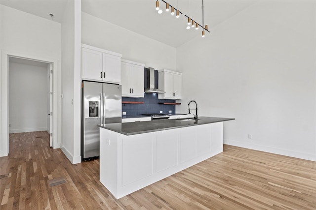 2120 Lovedale Ave Unit 101, Dallas, TX 75235 - kitchen with stainless steel fridge, wall chimney exhaust hood, high vaulted ceiling, backsplash, and open floor plan