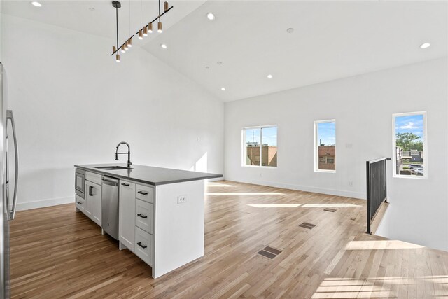 2120 Lovedale Ave Unit 101, Dallas, TX 75235 - kitchen featuring stainless steel appliances, wall chimney exhaust hood, open shelves, and dark countertops