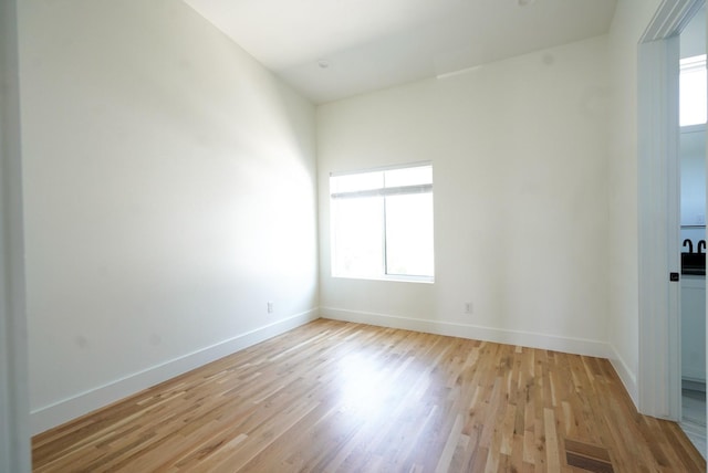 spare room with light hardwood / wood-style flooring